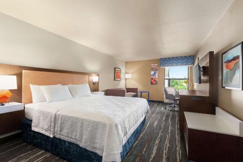 a hotel room with a bed and a desk at Hampton Inn Sacramento/Rancho Cordova in Rancho Cordova