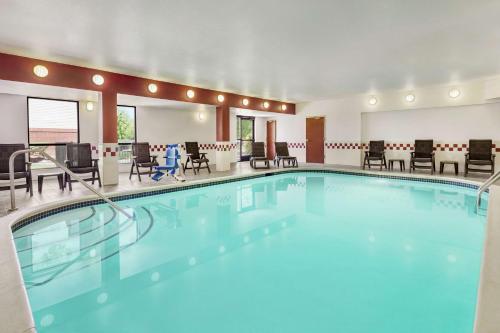 a pool in a hotel room with tables and chairs at Hampton Inn Sacramento/Rancho Cordova in Rancho Cordova