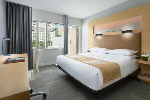 a hotel room with a large bed and a window at The Gates Hotel South Beach in Miami Beach