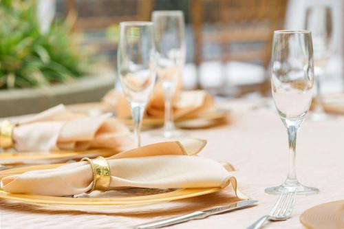 a table with two wine glasses and a napkin at The Gates Hotel South Beach in Miami Beach