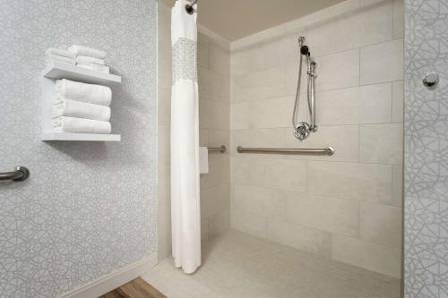 y baño con ducha y toallas blancas. en Hampton Inn Phoenix-Chandler, en Chandler