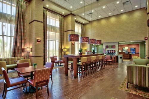 a restaurant with tables and chairs in a lobby at Hampton Inn & Suites Scottsdale at Talking Stick in Scottsdale