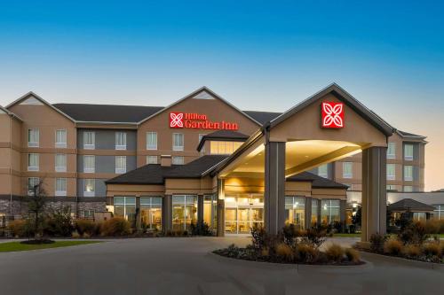 a hotel building with a sign on the front of it at Hilton Garden Inn Ardmore in Ardmore