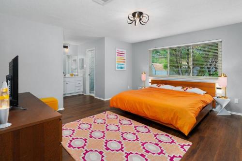 a bedroom with a bed and a desk and a television at That 70s House -Fun 6 Bedroom W Pool & Game Room in Round Rock
