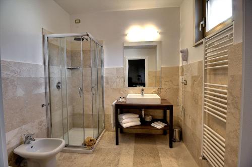 a bathroom with a toilet, sink, and shower at Hotel Park in Castiglion Fiorentino