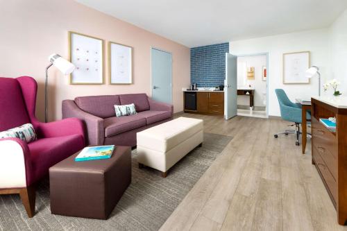 a living room with purple furniture and a desk at Hilton Garden Inn Key West / The Keys Collection in Key West