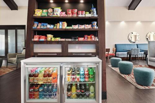 a refrigerator filled with lots of drinks in a lobby at Hampton Inn & Suites Fort Wayne-North in Fort Wayne