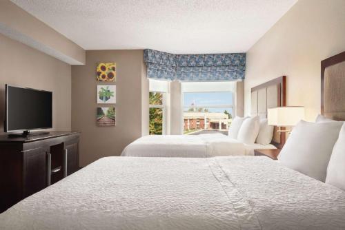 a hotel room with two beds and a window at Hampton Inn & Suites Fort Wayne-North in Fort Wayne