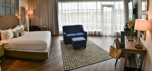 a hotel room with a bed and a blue chair at The Hotel Concord in Concord