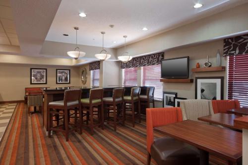 a conference room with a table and chairs and a tv at Hampton Inn St. Louis/Fairview Heights in Fairview Heights