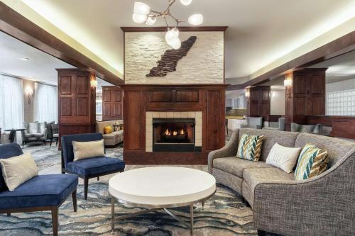 a living room with a fireplace and couches at Homewood Suites by Hilton Erie in Erie