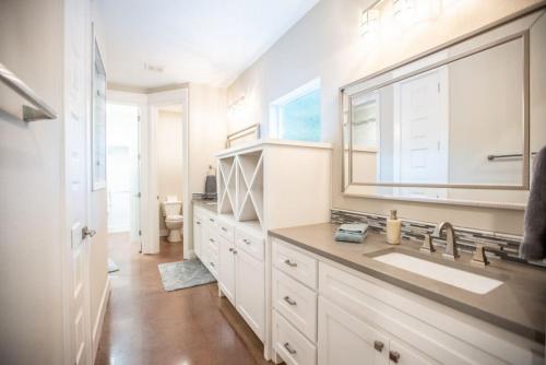 a white bathroom with a sink and a mirror at The Coffee House in Pottsboro