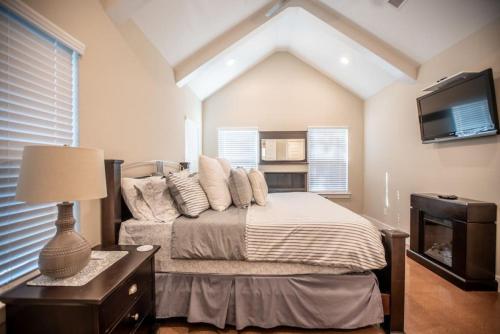 a bedroom with a bed with pillows and a tv at The Coffee House in Pottsboro