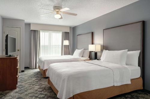 a hotel room with two beds and a flat screen tv at Homewood Suites by Hilton Corpus Christi in Corpus Christi