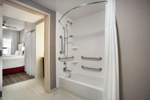a bathroom with a shower and a bath tub at Homewood Suites by Hilton Phoenix-Chandler in Chandler