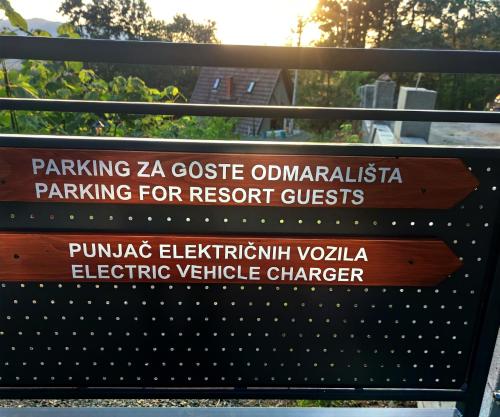 a sign for the parkza castle olympinianinian parking for resort guests at Seoski Turizam Feniks - Vajat Ostrog in Kosjeric