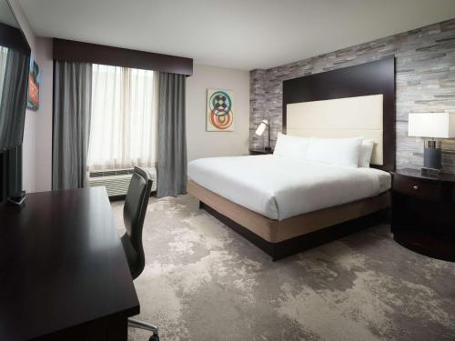 a hotel room with a bed and a desk at DoubleTree by Hilton Hotel Chattanooga Downtown in Chattanooga