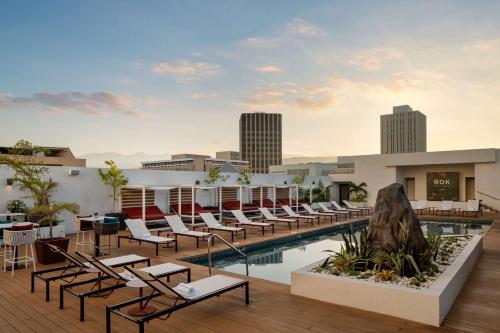 un hôtel avec une piscine et des chaises longues dans l'établissement ROK Hotel Kingston Tapestry Collection By Hilton, à Kingston