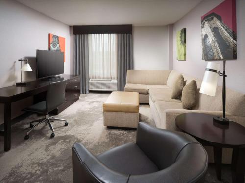 a living room with a couch and a desk at DoubleTree by Hilton Hotel Chattanooga Downtown in Chattanooga