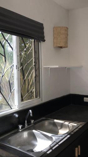 a sink in a kitchen with a window at NEW MORINGA in Las Terrenas