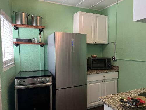 a kitchen with a refrigerator and a microwave at Cosy 3-Bedroom Downtown Walk to Convention Center in Tampa