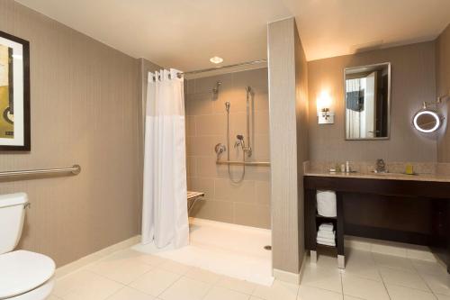 a bathroom with a shower and a toilet and a sink at DoubleTree Suites by Hilton Nashville Airport in Nashville