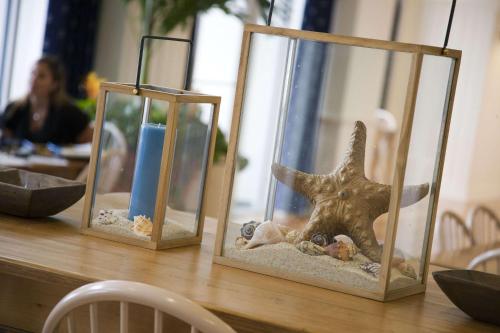 a table with two aquariums with a dinosaur in it at Hampton Inn & Suites Myrtle Beach Oceanfront in Myrtle Beach