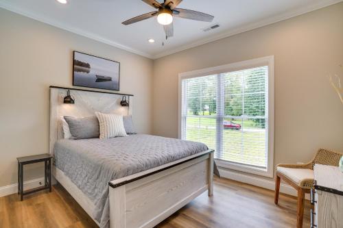 1 dormitorio con 1 cama, ventilador de techo y ventana en Modern Kentucky Lake Home Pool and Boat Ramp Access, en Aurora