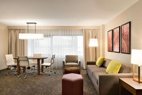 a living room with a couch and a table at Embassy Suites by Hilton Phoenix Downtown North in Phoenix