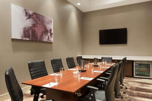 a conference room with a large wooden table and chairs at Embassy Suites by Hilton Phoenix Downtown North in Phoenix