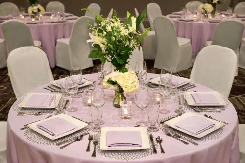 a table with purple table cloths and a vase of flowers at Embassy Suites by Hilton Phoenix Downtown North in Phoenix