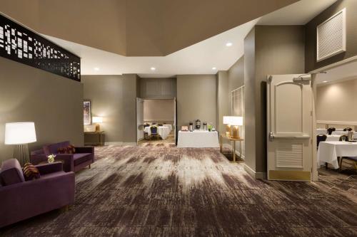 a large room with couches and tables and a refrigerator at Embassy Suites by Hilton Phoenix Downtown North in Phoenix