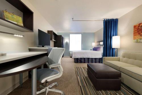 a hotel room with a desk and a bed at Home2 Suites by Hilton Anchorage/Midtown in Anchorage