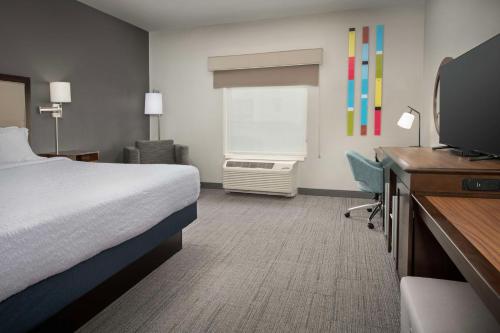 a hotel room with a bed and a television at Hampton Inn & Suites Portland/Hillsboro-Evergreen Park in Hillsboro