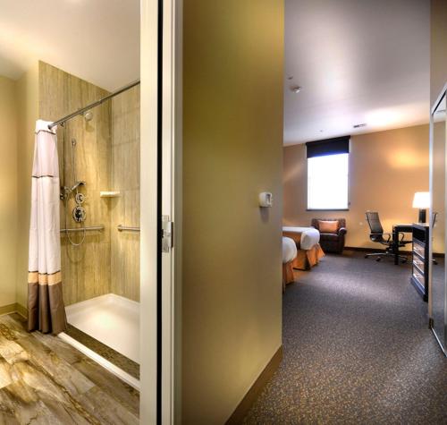 a hotel room with a shower and a bathroom at Hotel Maison Yakima Tapestry Collection by Hilton in Yakima