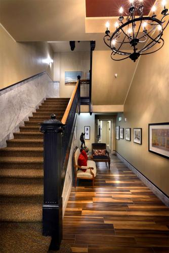 a staircase in a house with a chandelier at Hotel Maison Yakima Tapestry Collection by Hilton in Yakima