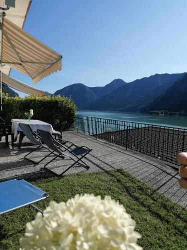 a patio with a table and chairs and a lake at Holiday Apartment Anna 63 Idro in Anfo