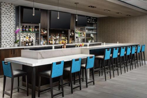 a bar with blue chairs and a white counter at Hilton Garden Inn Yakima Downtown in Yakima