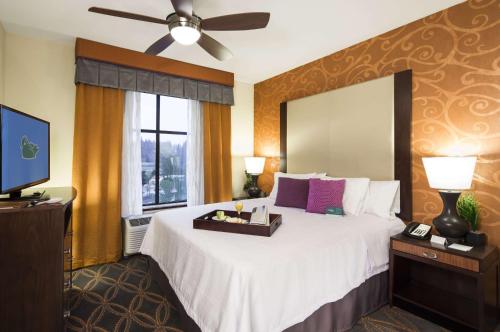 a bedroom with a large bed and a television at Homewood Suites by Hilton Seattle/Lynnwood in Lynnwood
