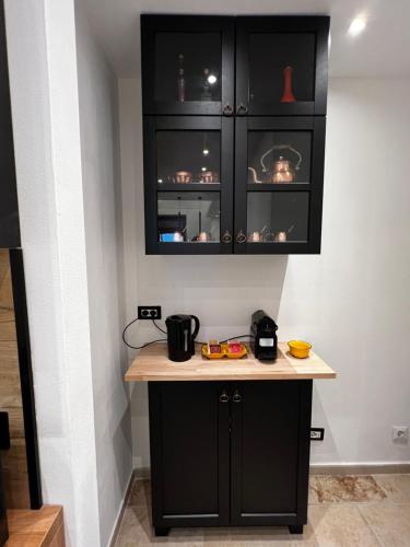 une cuisine avec des armoires noires et un comptoir dans l'établissement Casa Nada, à Porto Torres