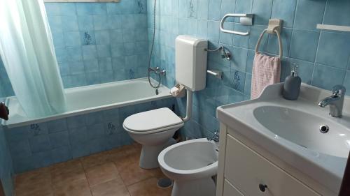 uma casa de banho azul com um WC e um lavatório em Casa da Torre Alta em Lagos
