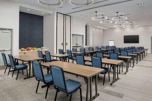 a conference room with tables and chairs and a chalkboard at Hilton Garden Inn San Jose Airport in San Jose