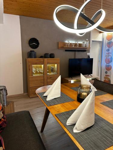 a dining room with a table with paper napkins on it at Appartementhaus Birkenwald in Seefeld in Tirol