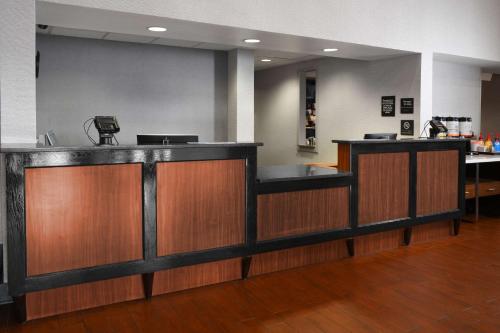a lobby with a bar with wooden cabinets and a unintention at Hampton Inn & Suites Houston-Medical Center-NRG Park in Houston