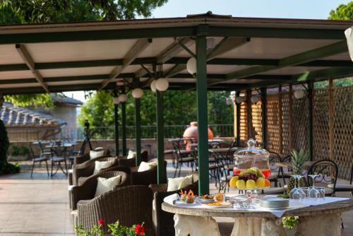 a patio with a table with food on it at Hotel Ristorante Borgo Antico in Monteroni dʼArbia