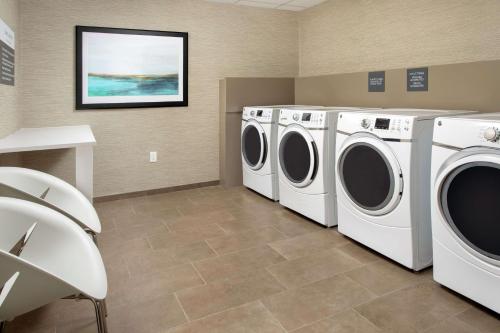 a laundry room with two washer and dryer at Hilton Garden Inn Westchester Dobbs Ferry in Dobbs Ferry