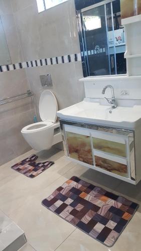 a bathroom with a sink and a toilet at Broadhurst Homestay in Gaborone