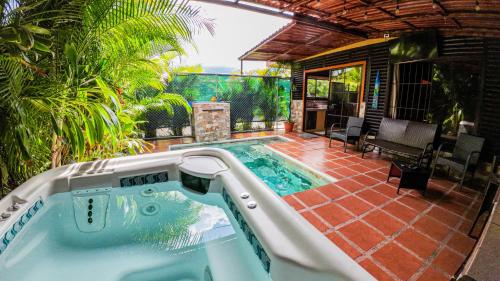 a swimming pool in the middle of a patio at Bungalows Las Iguanas Arenal Volcano in Chachagua