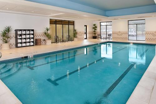 a large swimming pool with blue water in a building at Hilton Garden Inn Denver Tech Center in Denver