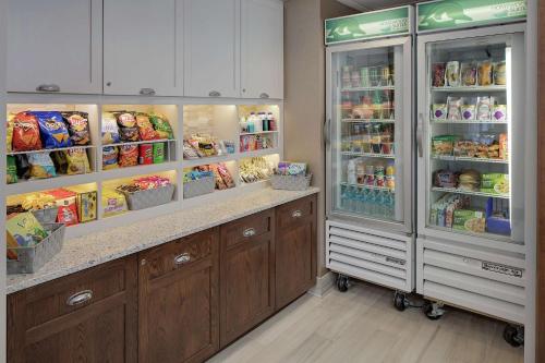 a kitchen with two refrigerators with food in them at Homewood Suites by Hilton Minneapolis-Mall Of America in Bloomington
